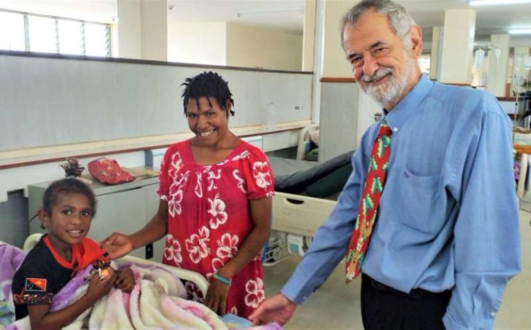 Image of WHPHA CEO, David Vorst greets a child.