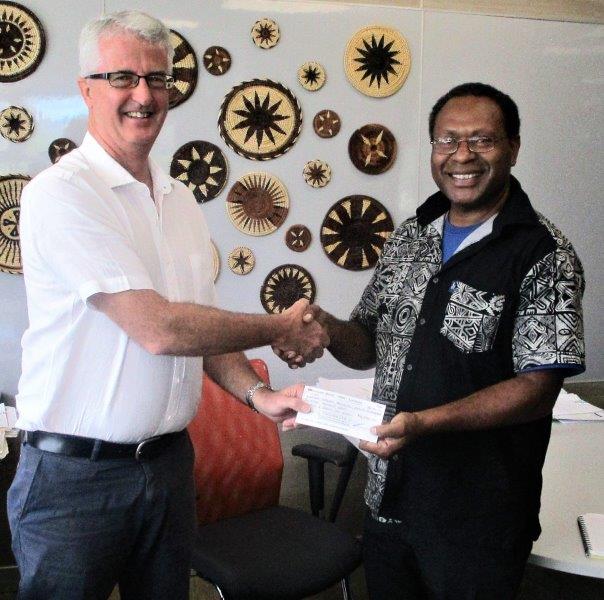 Image of Dr Jonah Kurubi (right) accepting the cheque of K16,000 from the Managing Director of Tininga, Mr Pat Duckworth.
